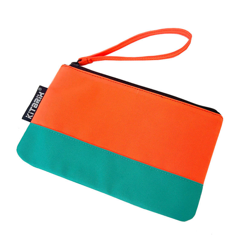 Compact and stylish duo-color pouch with a convenient wrist strap for handkerchief storage.